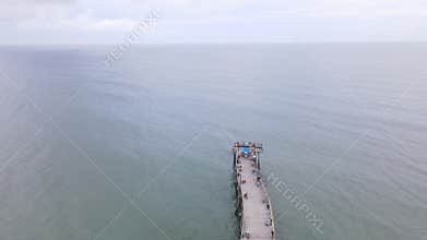 An aerial view of a fishing pier and the ocean in the town of Avon, North Carolina.