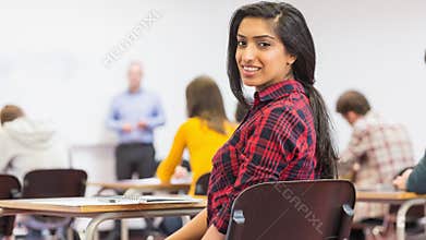 Female with blurred teachers students in classroom
