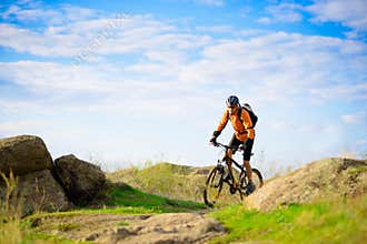 Cyclist Riding the Bike on the Beautiful Mountain Trail