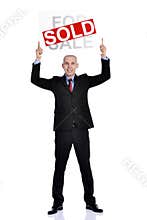 Real estate man holding a for sale sold sign