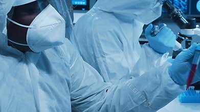 Scientific laboratory filled with various research equipment. Scientists are conducting experiments and research