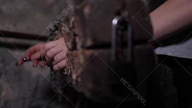 Close-up of a woman's hands in antique wooden shackles with a chain. Quest room