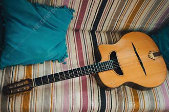 Gypsy jazz acoustic guitar on a colorful blanket