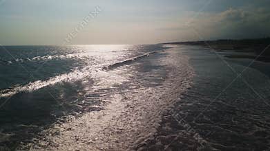 Ocean Waves Crashing On Bali Shoreline At Sunset