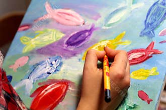 Artists hand with paintbrush painting the picture