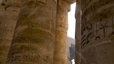 Large Egyptian columns with hieroglyphs in the ruined temple at Karnak