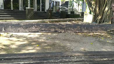 a view of the broken wooden bench in the park. Old benches are not maintained.