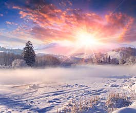 Beautiful winter sunrise in mountain village.
