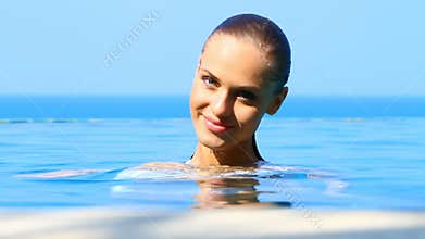 Lovely girl in exotic swimming pool