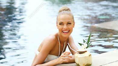 Adorable blond woman standing in swimming pool