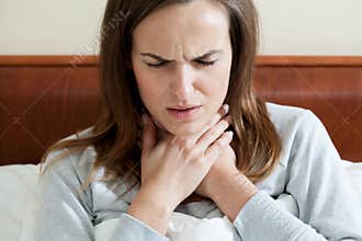 Woman having a sore throat