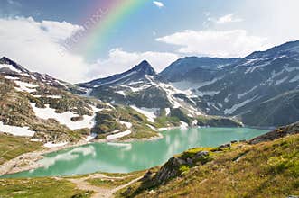 Rainbow over mountain lake in alps, Austria