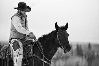 Black and white of cowboy with lasso