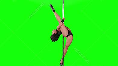 Young woman exercise pole dance against a