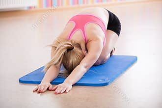 Young woman doing yoga exercise