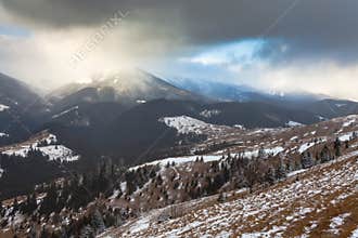 Sunset in winter mountains with dramatic light
