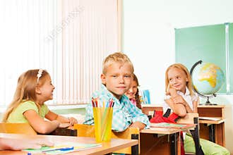 School children sitting at tables during geography