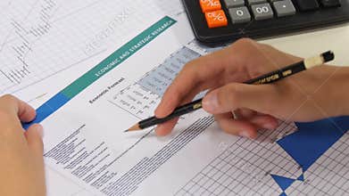Business woman analysis of financial reports.