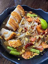 Crispy pork belly with glass noodle salad, lime and chili tossed with peanuts and vegetables for spicy tangy bite