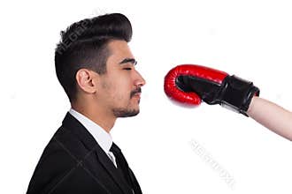 Business conflict concept. Young man in suit gets hit from boxer in boxing gloves