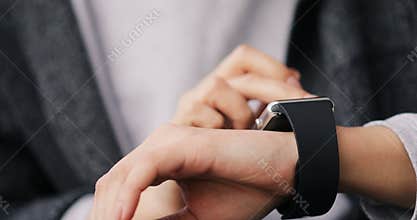 Young woman making gestures on her wearable smartwatch computer device, smart watch close up hands 4k