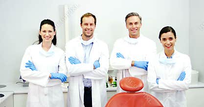 Smiling dentists standing with arms crossed