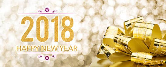 Happy new year 2018 with golden gift box with big bow at sparkling bokeh blur background,Holiday greeting card banner