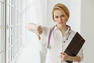 Closeup portrait, doctor woman, giving thumbs down gesture