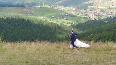 Wedding couple walks near mountain canyon
