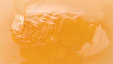 Honey pouring on honey in slow motion