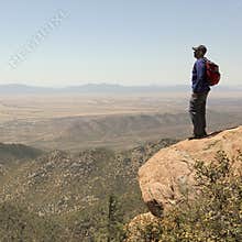A Bearded Man Hiking in the Mountains