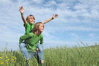 Happy kids playing piggyback race