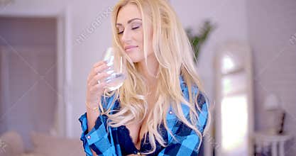 Pretty woman drinks water from glass