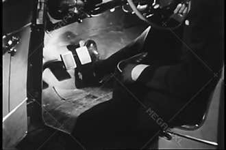 Man testing foot pedals in car