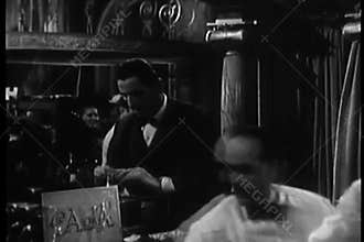 Waiters getting change from cashier in nightclub