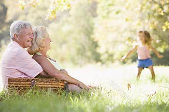 Grandparents at a picnic with young girl