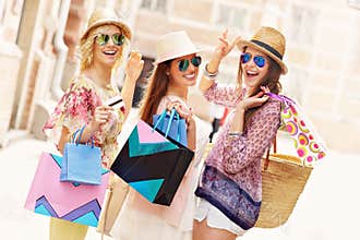 Group of happy friends shopping in the city