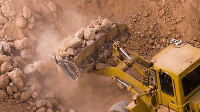 Top view excavator loading crushed rock on dumper truck