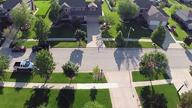 Flying over residential houses and yards along suburban street - Travel and leisure concept