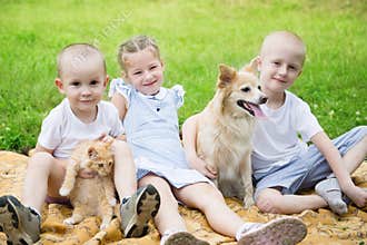 Sister and brothers with a dog and a cat