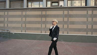 Business Woman Walking And Making a Phone Call Outdoor In City.
