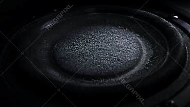 Bass loud speaker throws dust in the air. Super slow motion. Equalizer concept