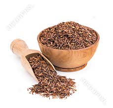 Rooibos tea in a wooden bowl isolated on white