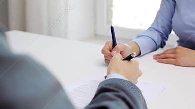Business partners with house model and contract