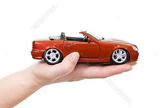Woman hand with holding red sports car