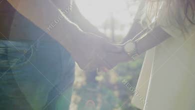 Couple Of Lovers Holding Hands On Sunset