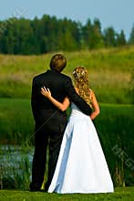 Bride and groom at pond