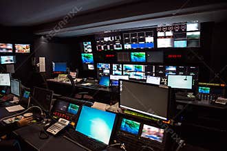 TV Broadcast news studio with many computer screens and control panels for live air broadcast.