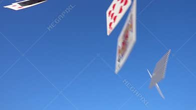 Playing cards falling on blue sky