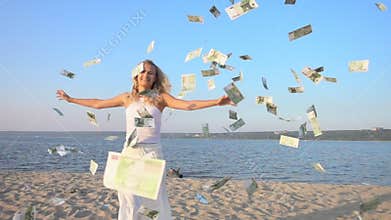 Happy young woman and money falling from sky.